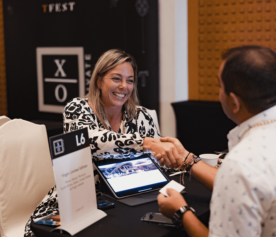 An exhibitor smiling across the table in a TFest meeting
