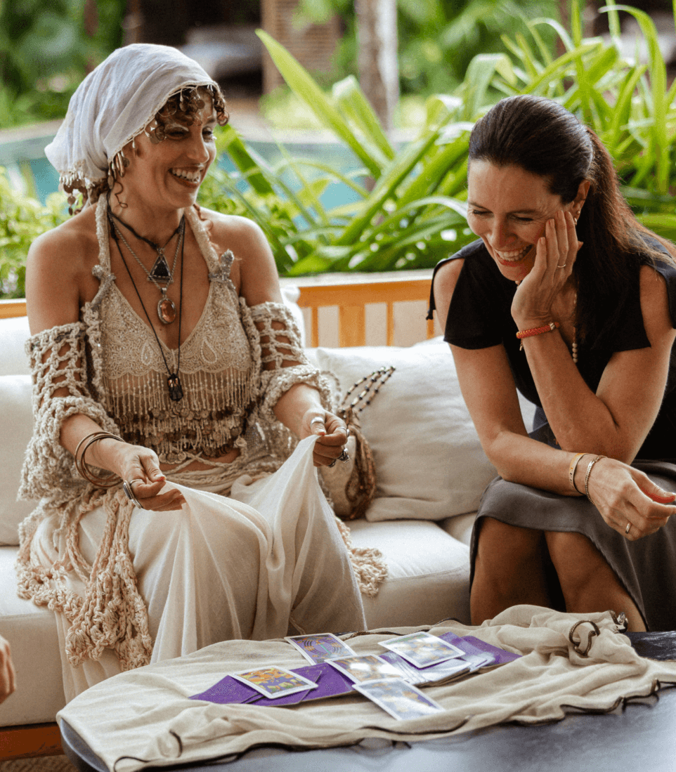 Two attendees laughing over tarot cards during an afternoon Pathway