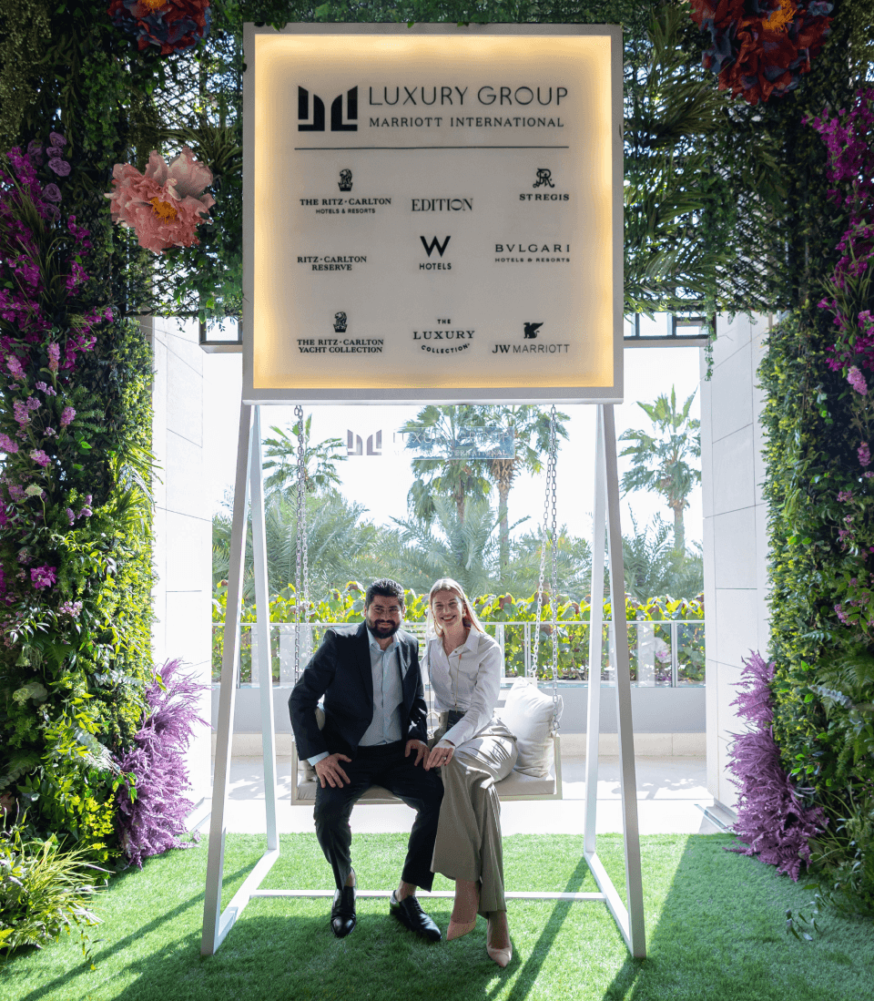 Two guests on a branded swing at a partner activation